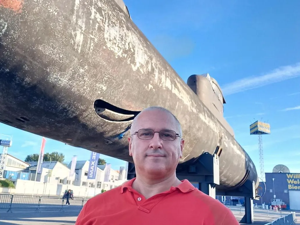 Sergey Raevsky next to a submarine at a technology museum