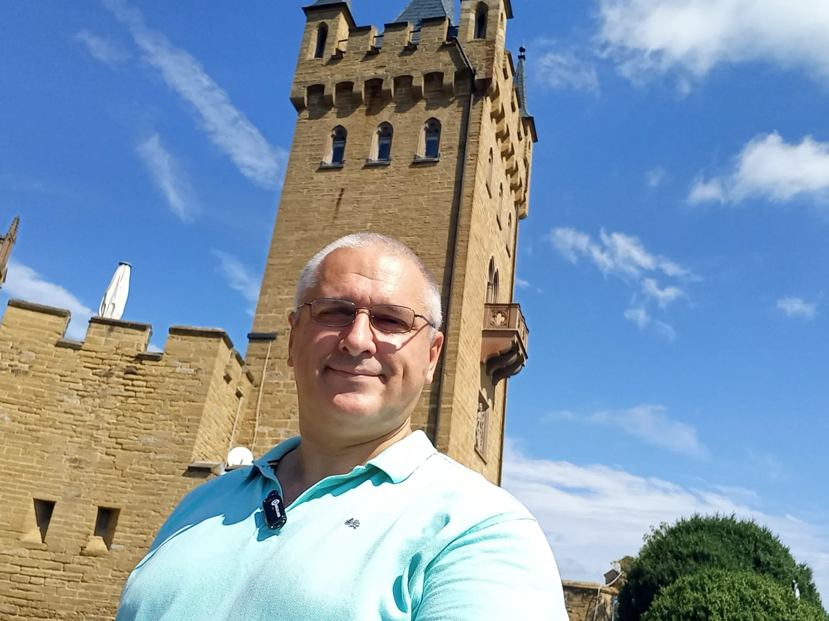 Sergey Raevsky in casual clothes in front of an old castle
