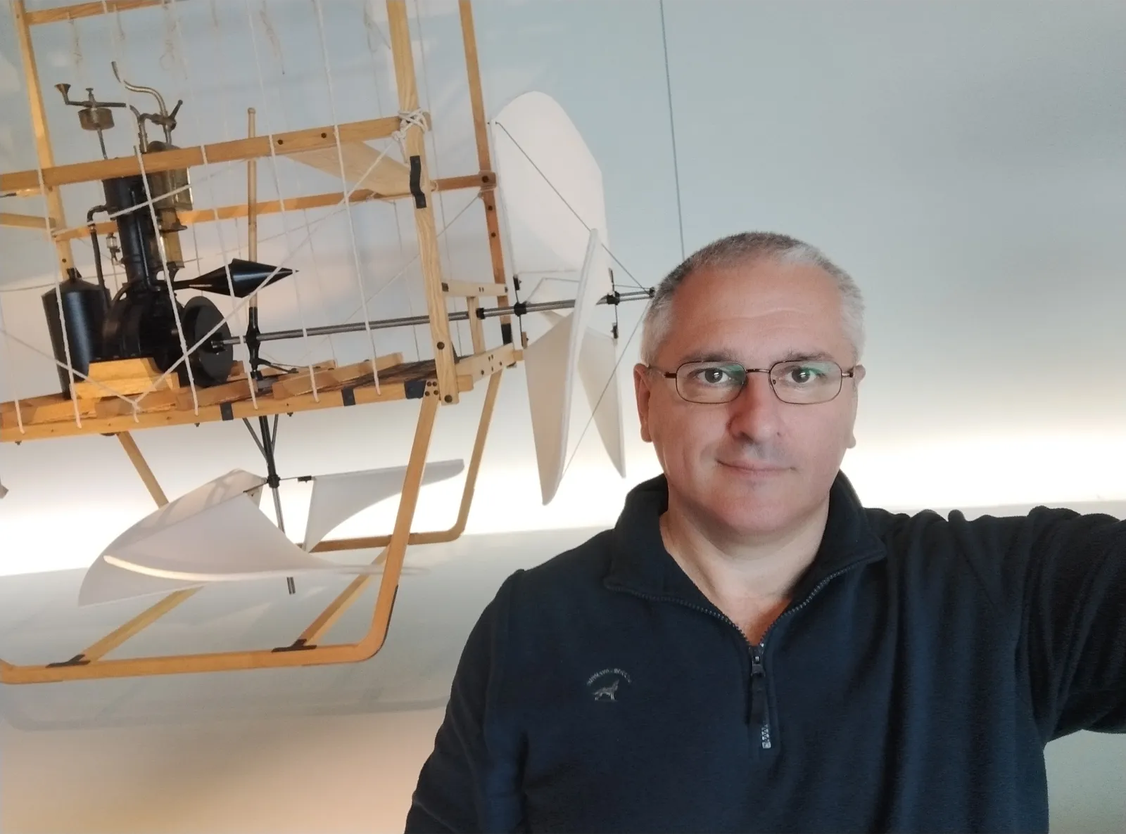 Sergey Raevsky next to an exhibit in a technical museum