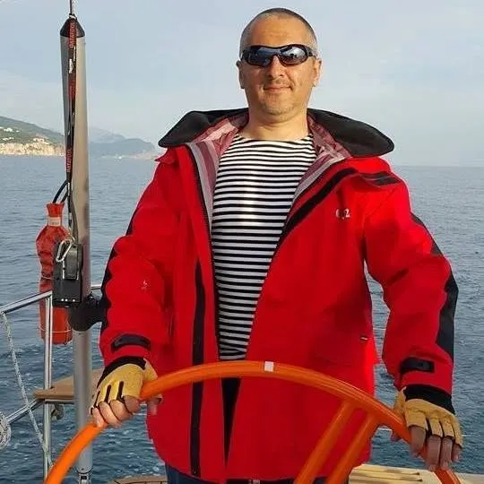 Sergey Raevsky at the helm of a sailing yacht